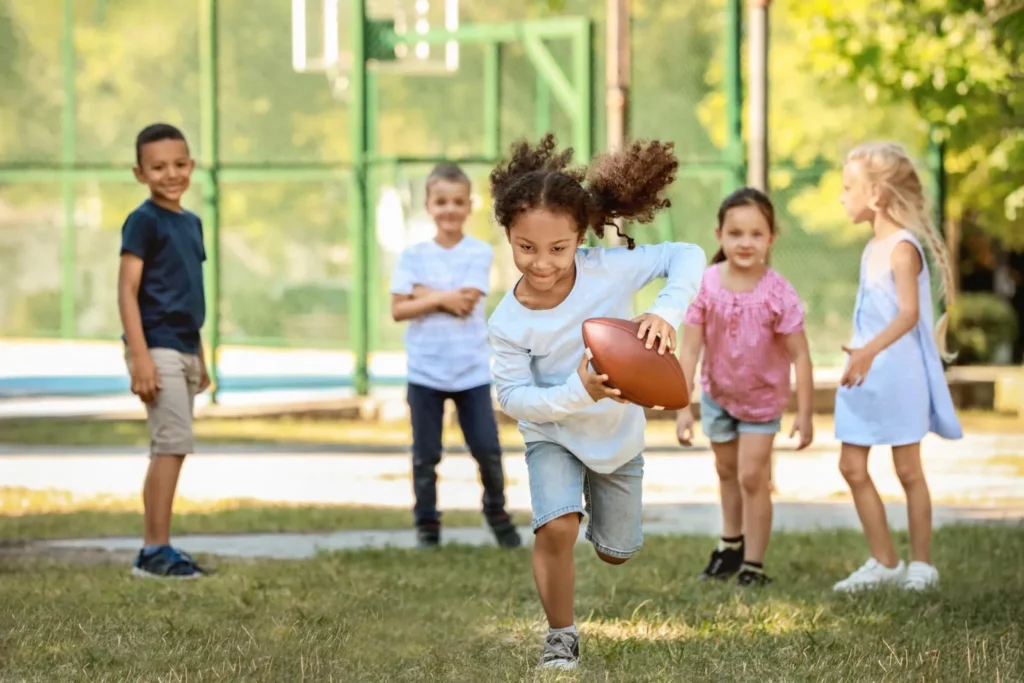 Girl Running With Football