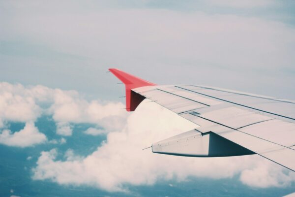 flying airplane surrounded by clouds